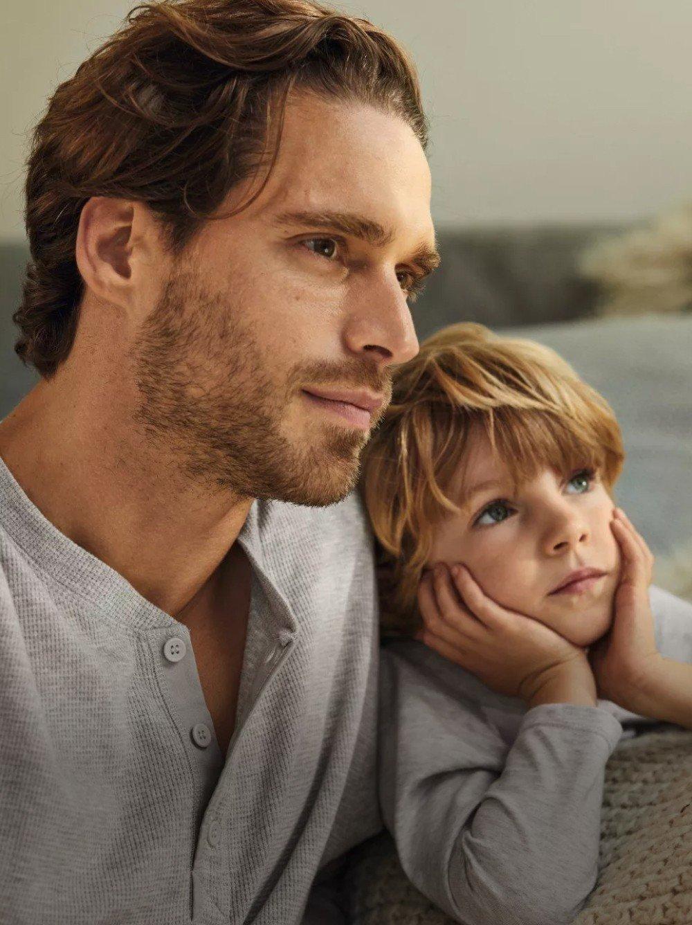 a man and a child sitting on a couch together