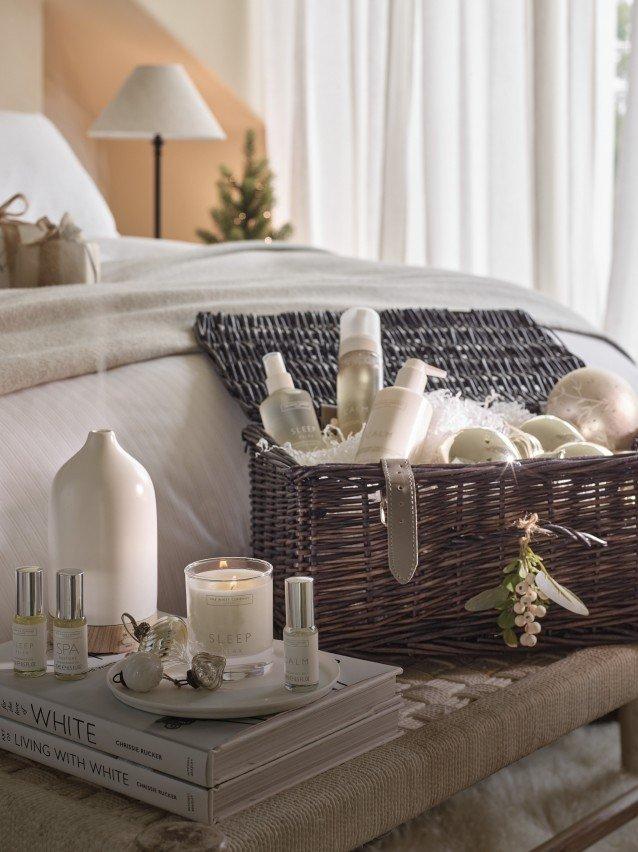 a bed with a blanket and a book on a table