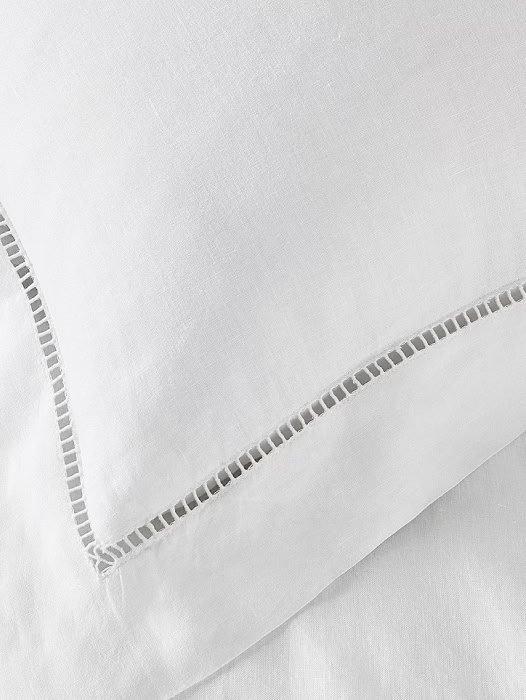 a close up of a white pillow with a white border