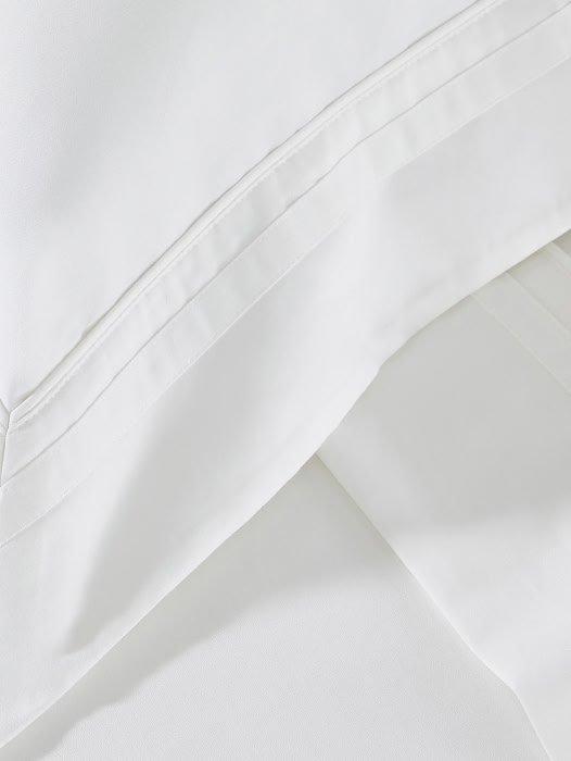 a close up of a white sheet with a folded edge