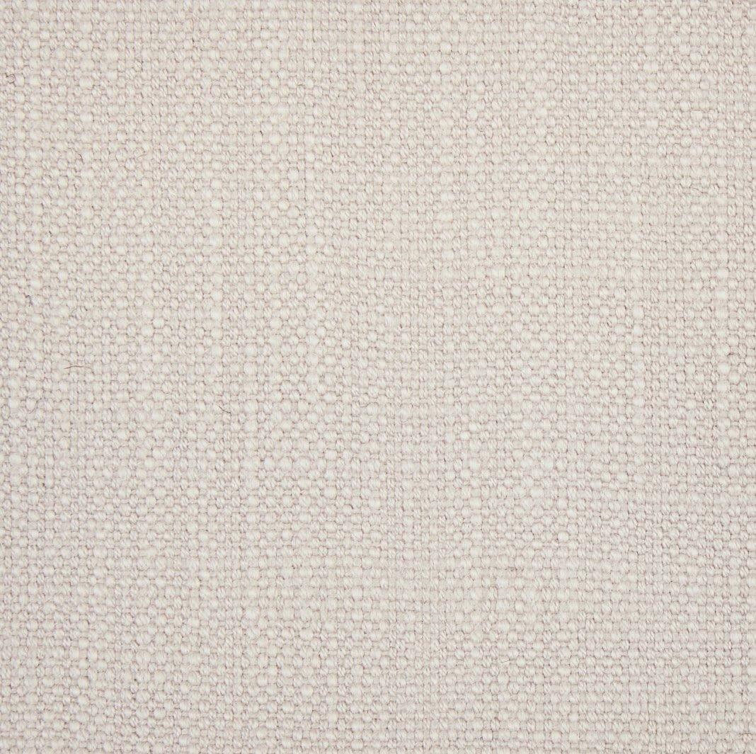 a close up view of a white fabric with small dots