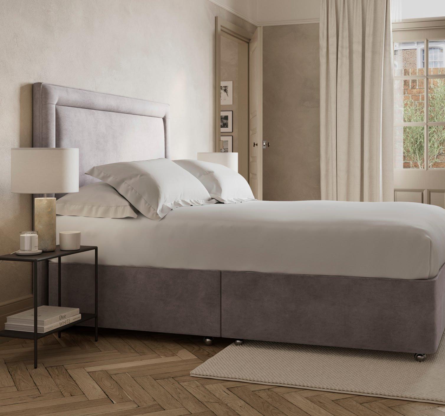 a bed with a white headboard and footboard in a bedroom
