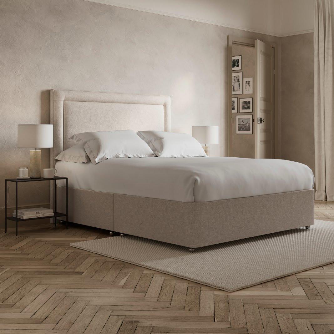 a bed with a white headboard and footboard in a bedroom