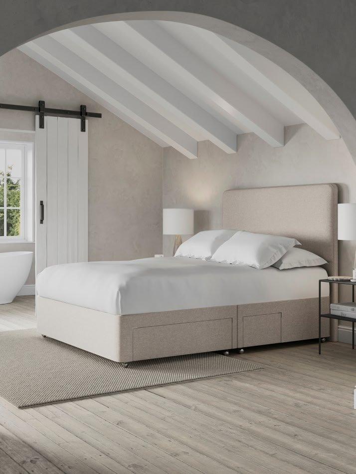 a bedroom with a bed, a bathtub and a window