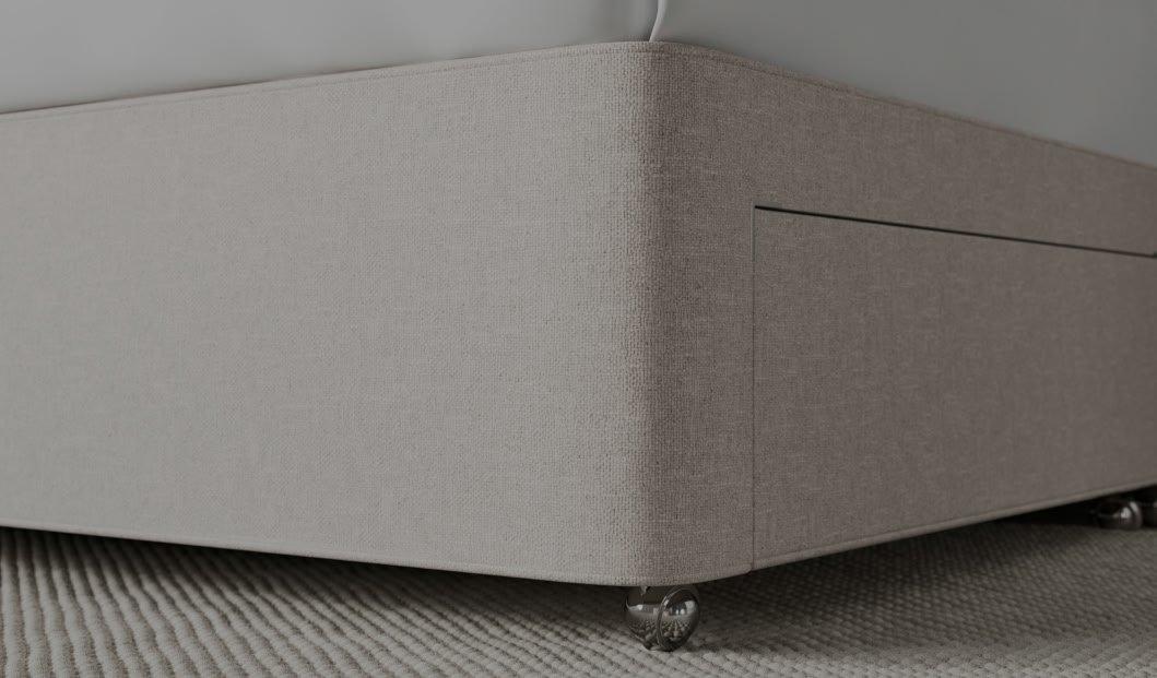 a close up of a bed with a white mattress and a white box spring