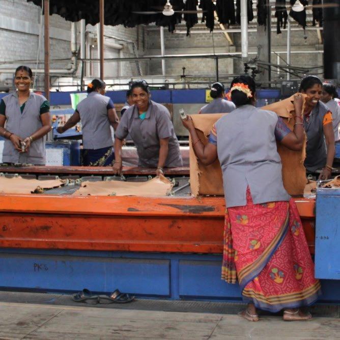 a group of women working on a sewing machine in a factory