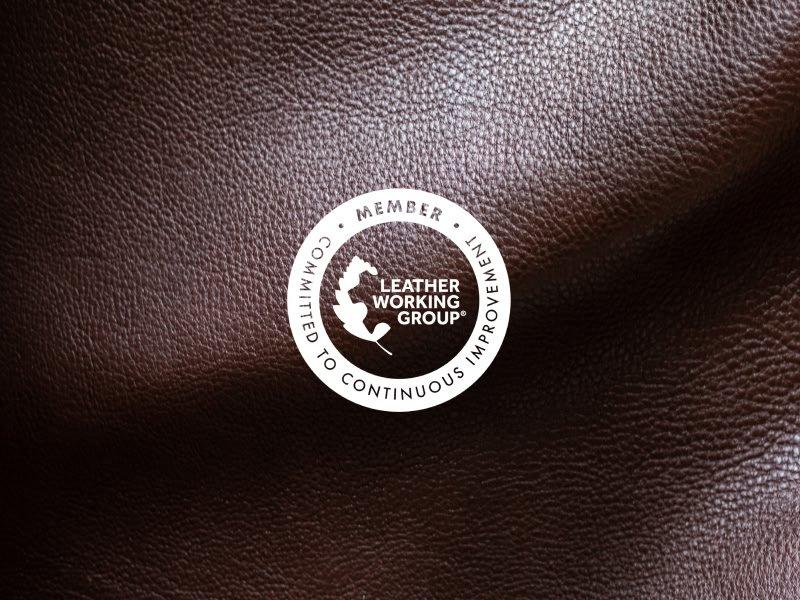 a close up of a brown leather surface with a white circle