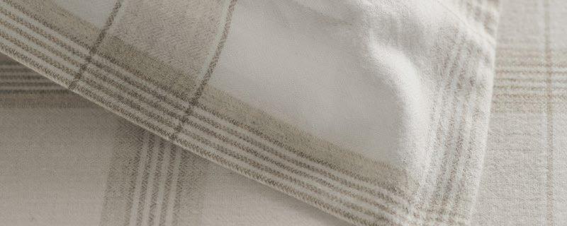 a close up of a white curtain with a black stripe