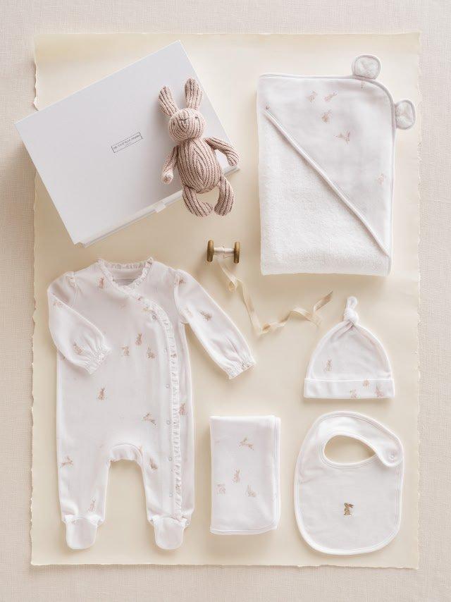 a white sweater and a white shirt next to a white box