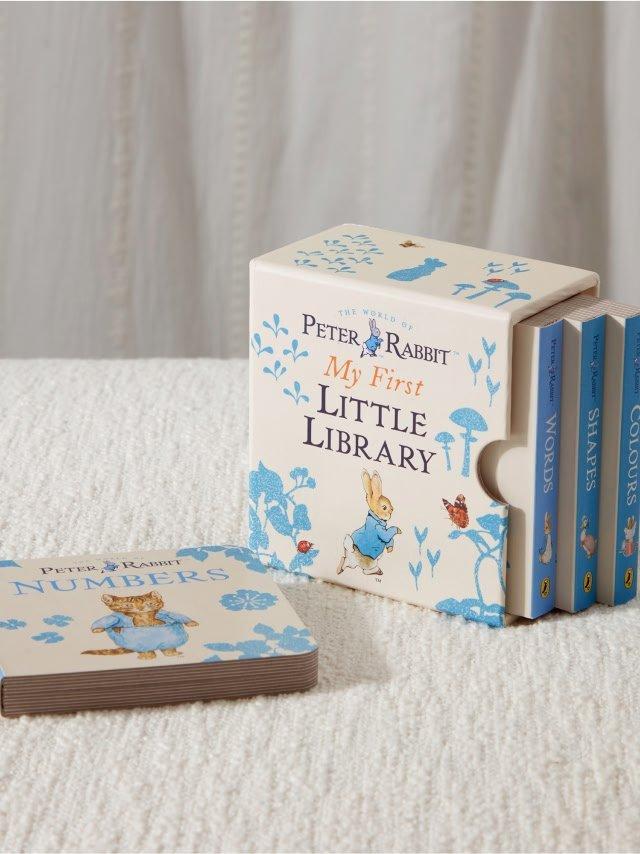a small book with a cover and a box next to it