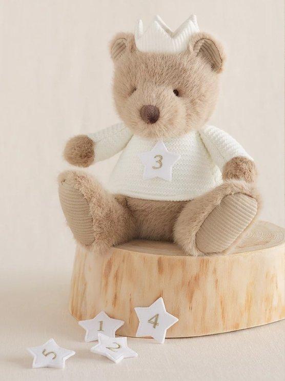 a small white star with numbers on it next to a wooden box