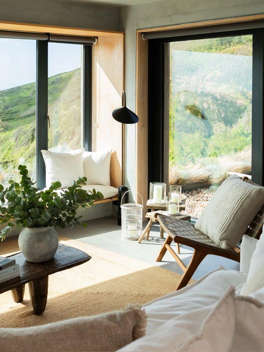 a living room with a large window overlooking a valley