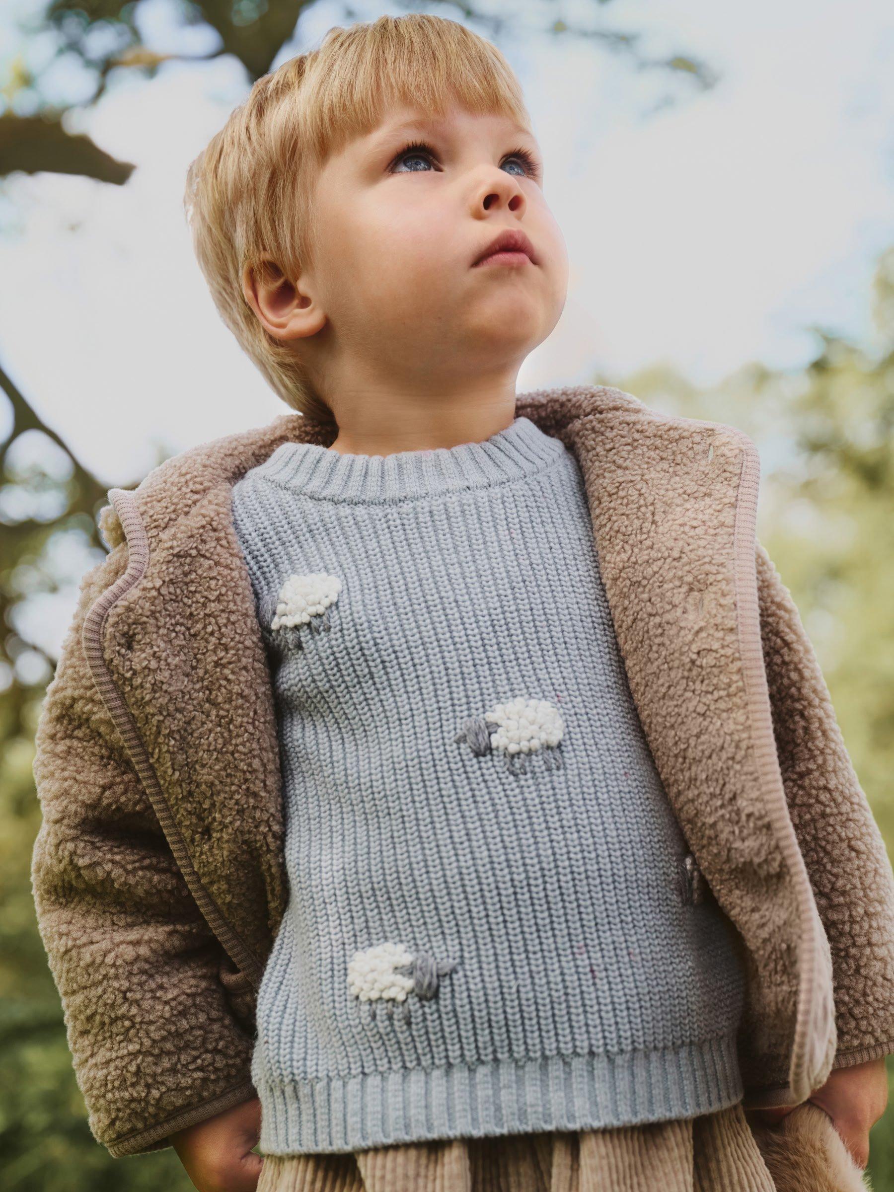 boy in a jumper and coat