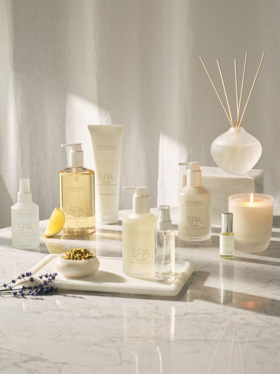 a marble counter top with various spa products on it