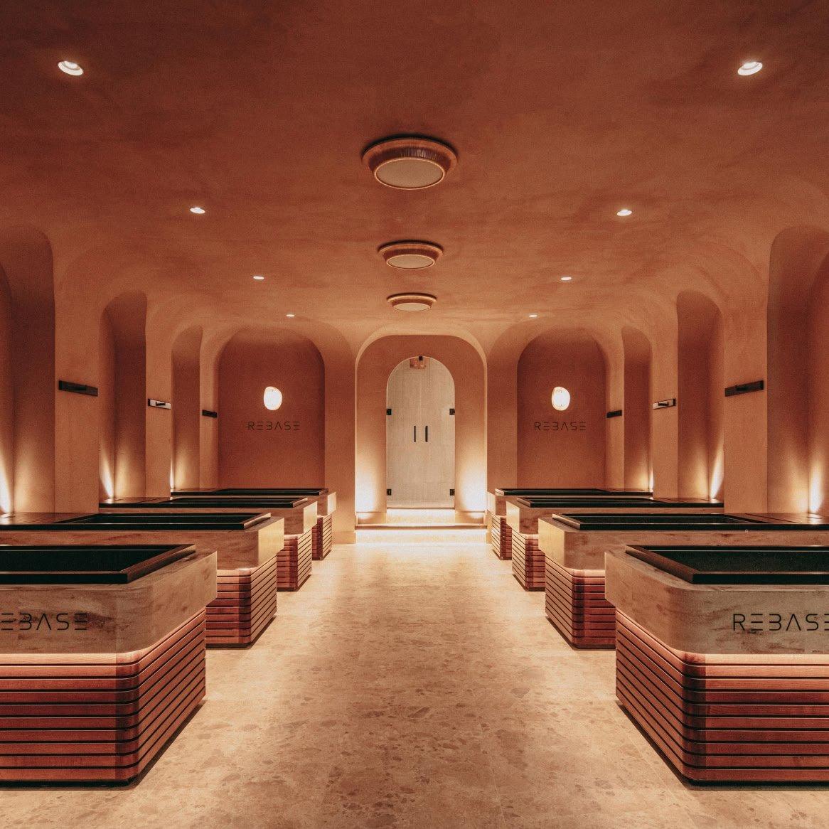 a long hallway with several benches and a lighted ceiling