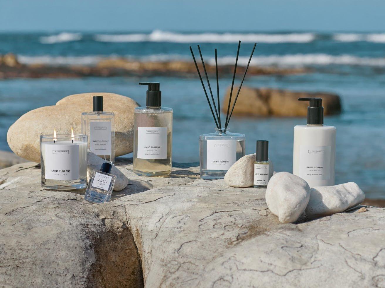 a group of bottles of perfume and other items on a rock