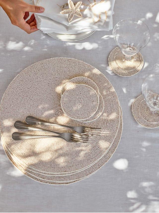 a table setting with a plate, fork, and knife on a white tablecloth