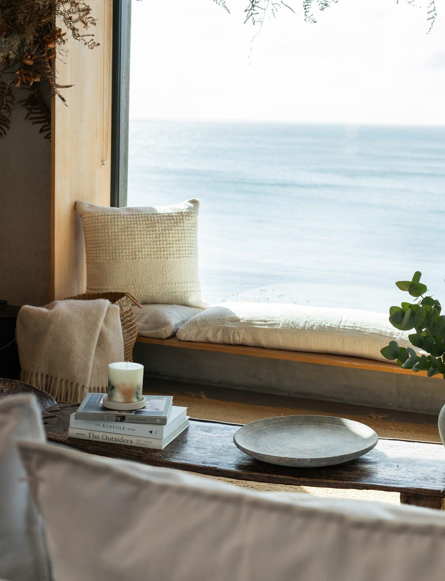a table with a vase of lemons and a plate of food