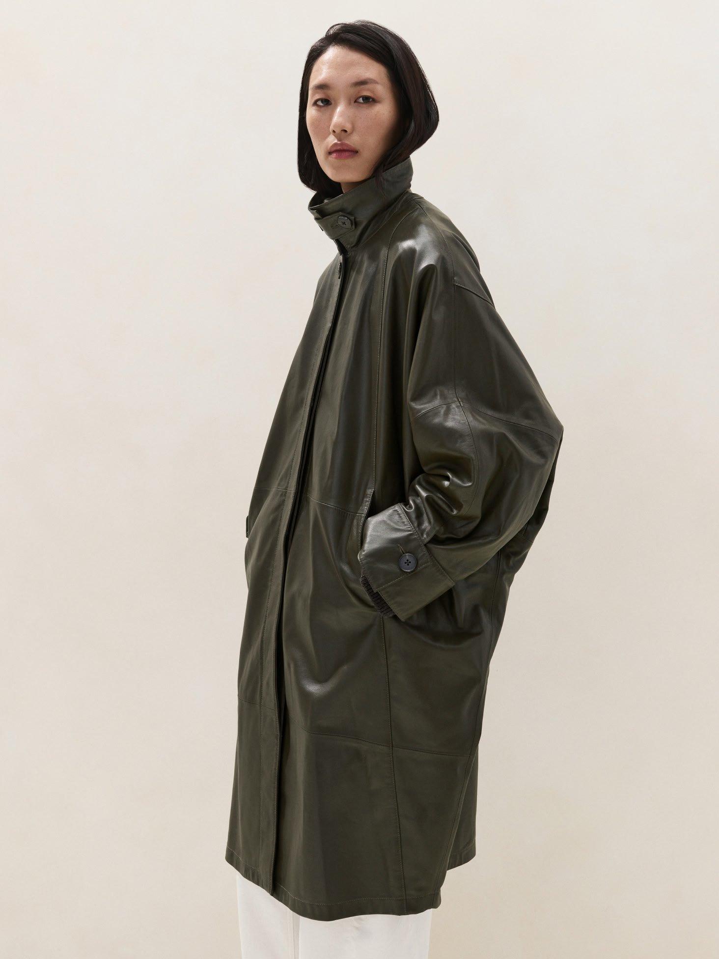 woman in leather trench cape