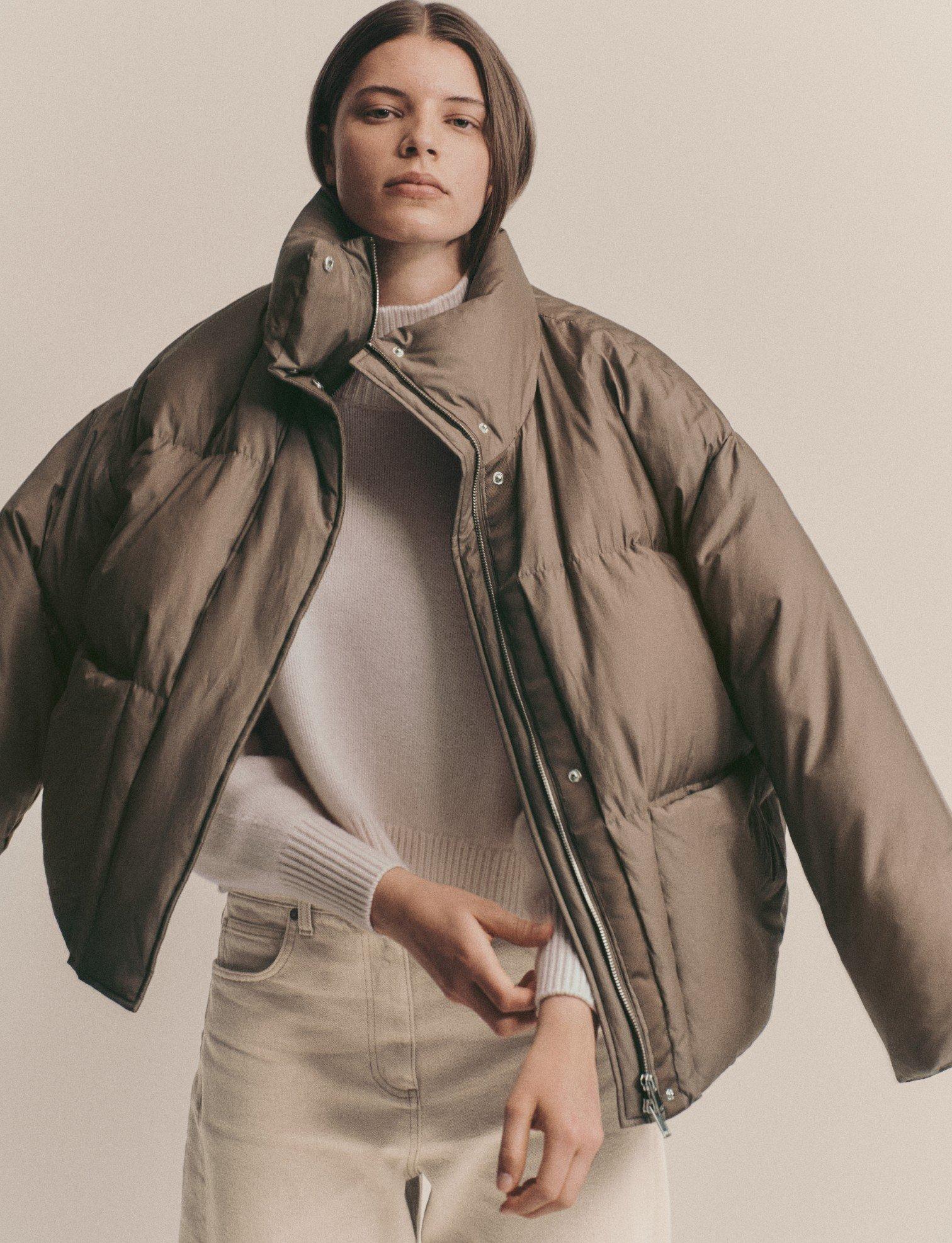 a woman in a puffy jacket posing for a photo shoot
