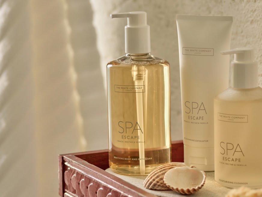 a shelf with a bottle of body wash and a bottle of body lotion