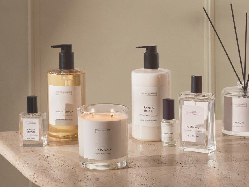 a counter with a variety of different scents and candles