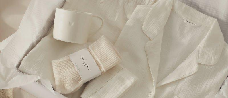 a white pajamas and a white mug are in a box