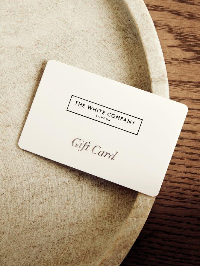 a white gift card sitting on top of a plate