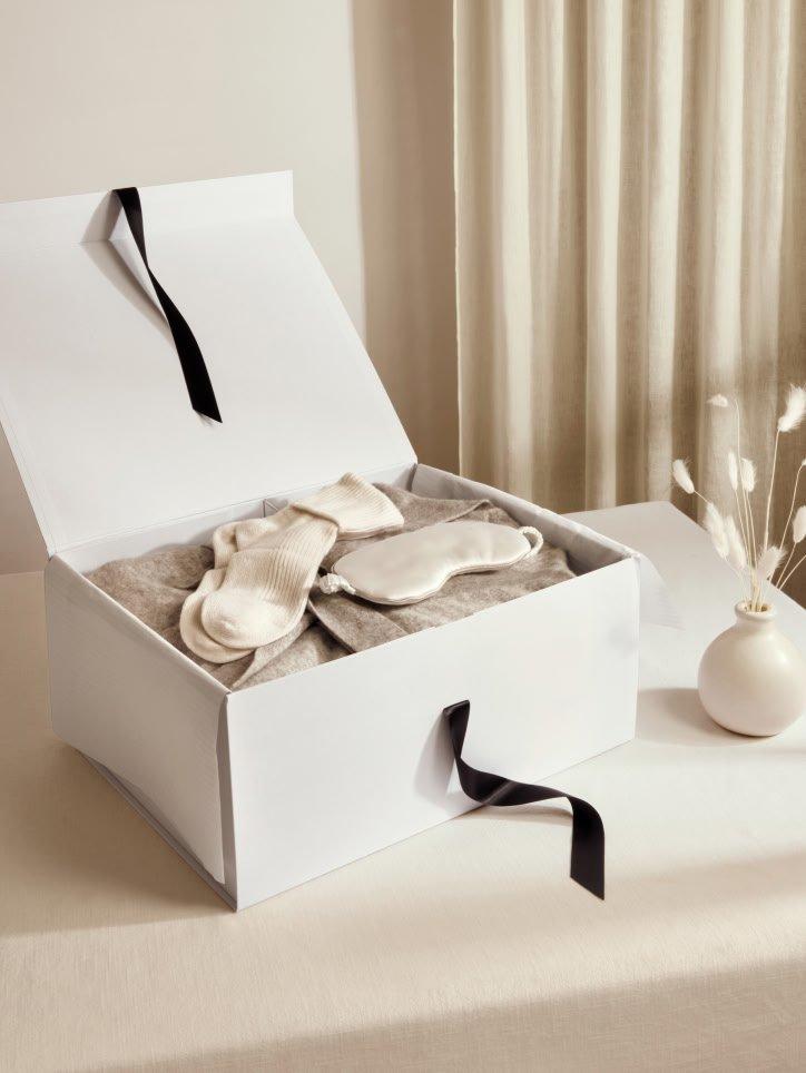 a white box with a bow on top of a table