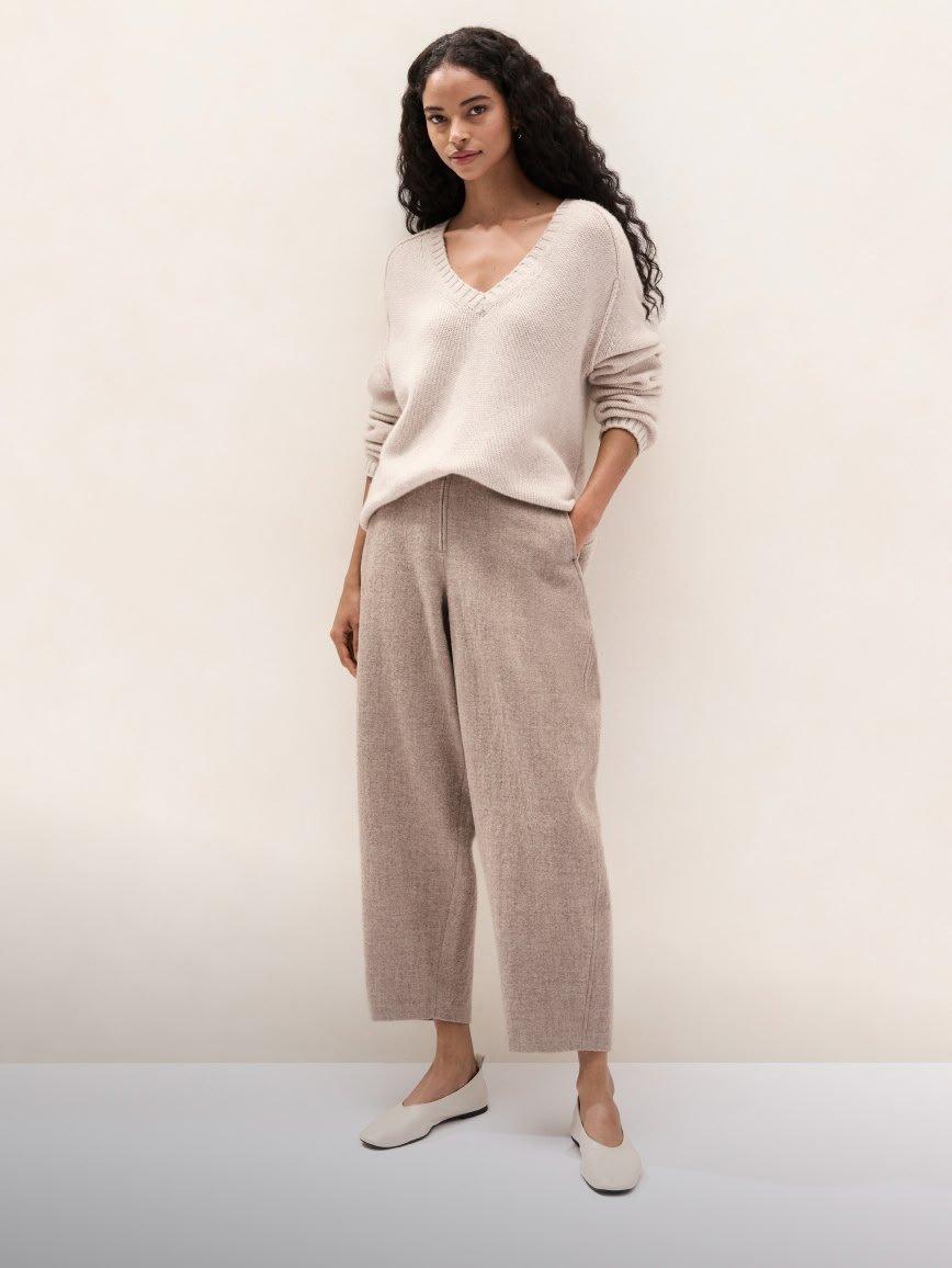 a woman in a white shirt and pants standing up
