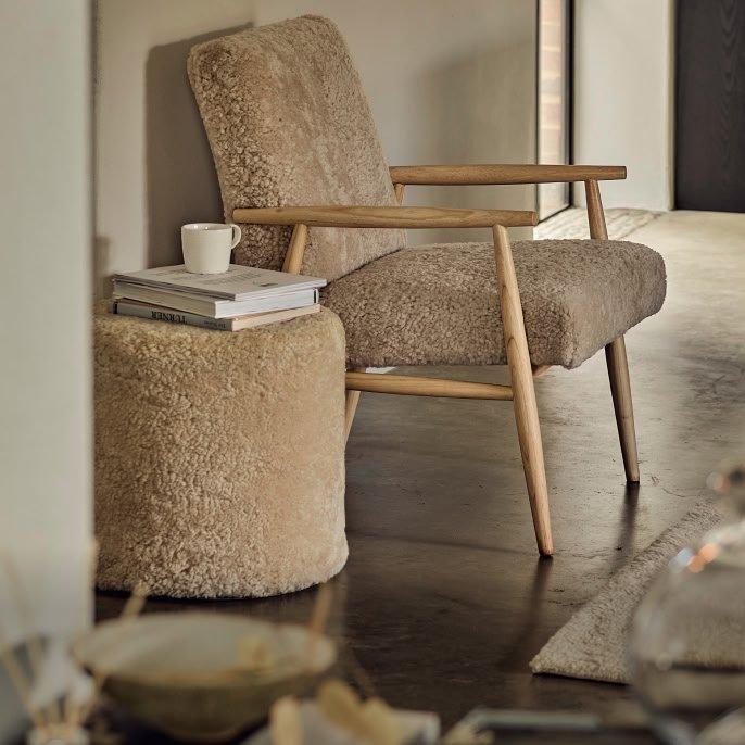a chair and ottoman in a room with a coffee table